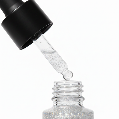 Close-up of matte black rubber dropper bulb and glass pipette tip of liquid glitter highlighter bottle