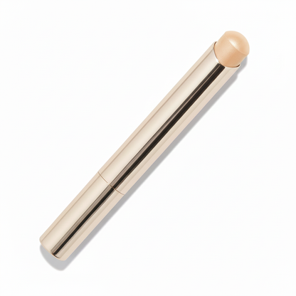 Polished champagne gold twist-up metal concealer stick with deep caramel brown dome cream tip