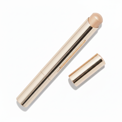 Polished champagne gold twist-up metal concealer stick with nude beige dome cream tip